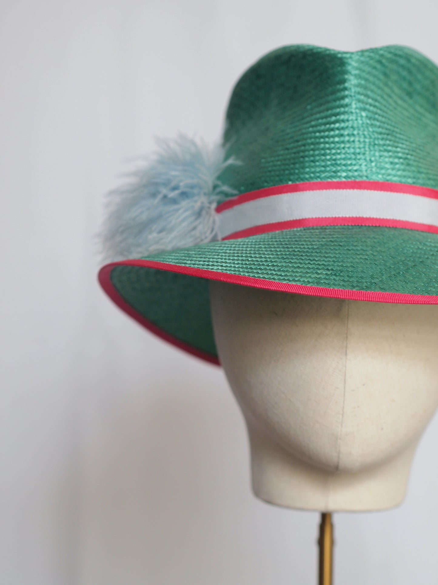 Green straw fedora with feather pom pom