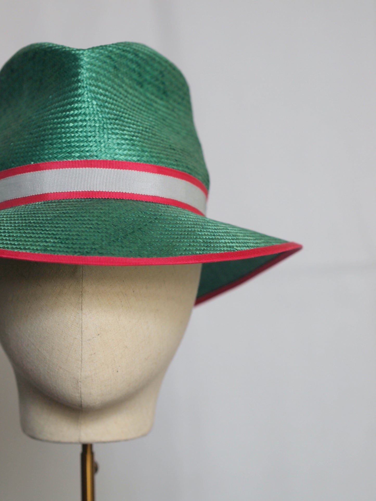 Green straw fedora with feather pom pom