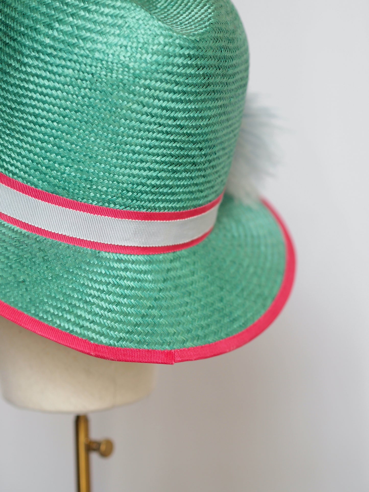 Green straw fedora with feather pom pom