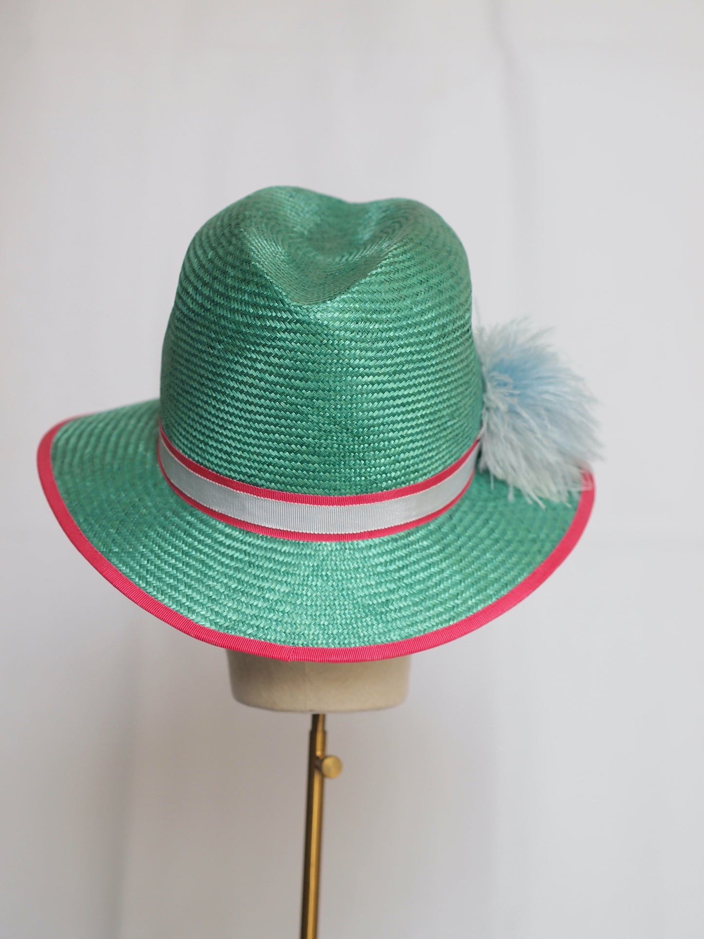 Green straw fedora with feather pom pom